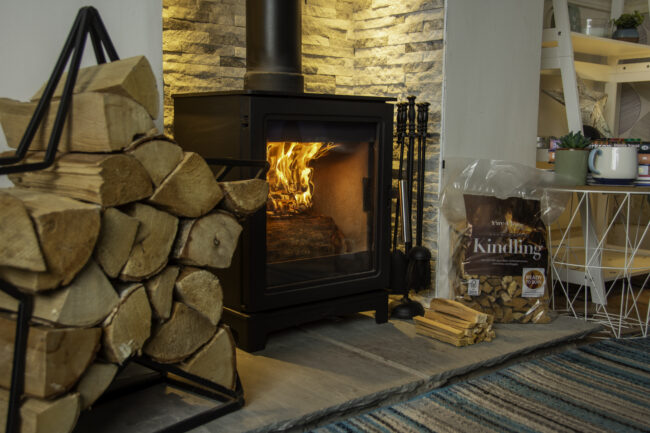 Cosy log burner with firewood and kindling.