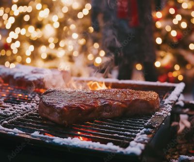 Grilled steaks with festive lights background